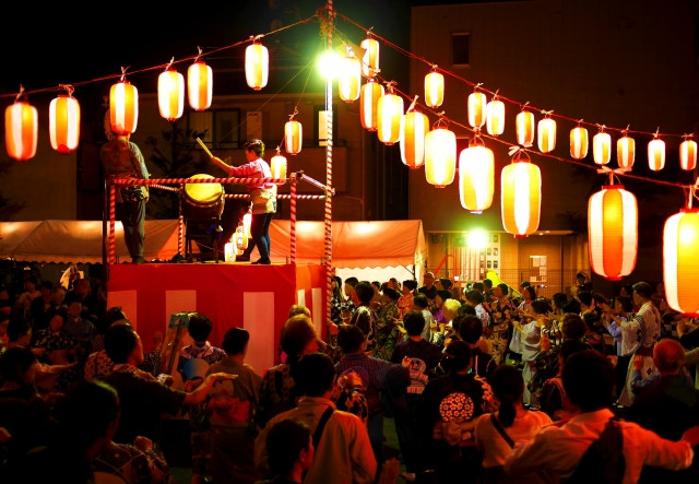 people gathered around yagura for bon odori dance