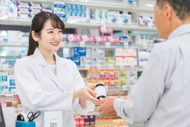 pharmacist handing medicine to patient