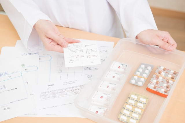 pharmacist with dispensed medicine and medicine information