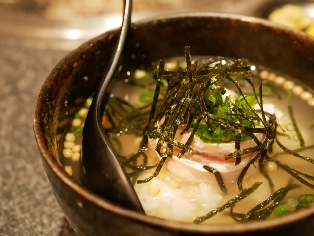 Close-up of chazuke with seaweed, spring onions and fish toppings