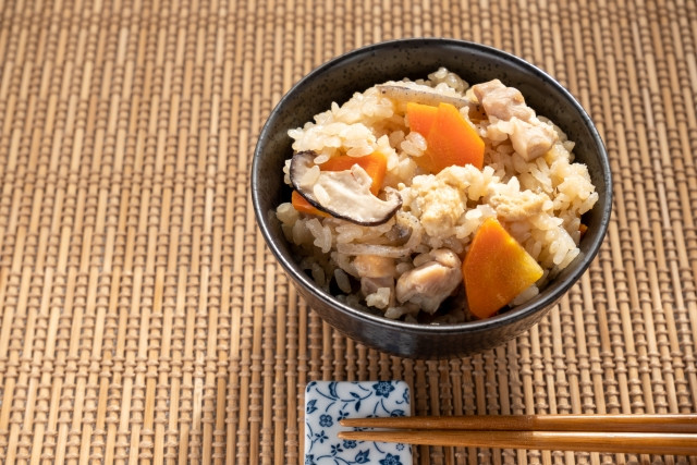 A bowl of takikomi gohan - carrots, mushroom, konyaku 