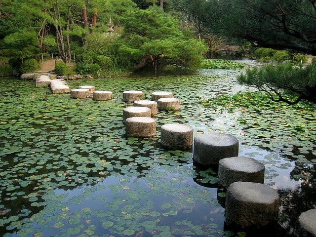 Rounded stone path over pond of Naka Shin'en