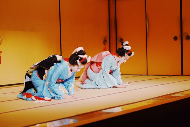 Geisha bowing after performance ends