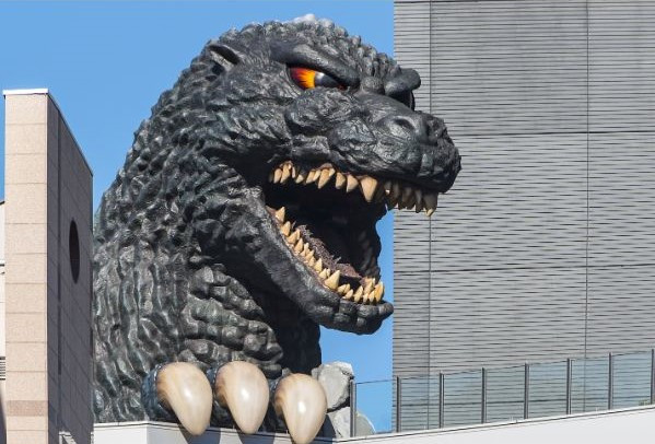 Godzilla peeking over building tops