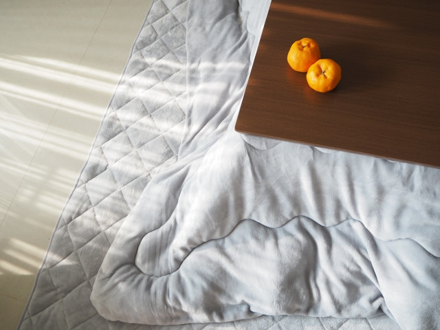 two ripe mikan on japanese kotatsu table