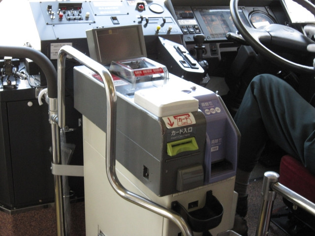 fare box or payment machine next to bus driver